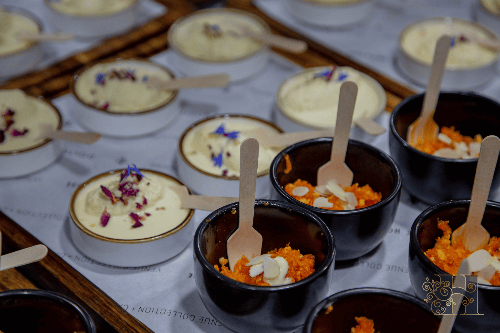 Assortment of Indian desserts featuring ras malai and gajar halwa served in decorative bowls.