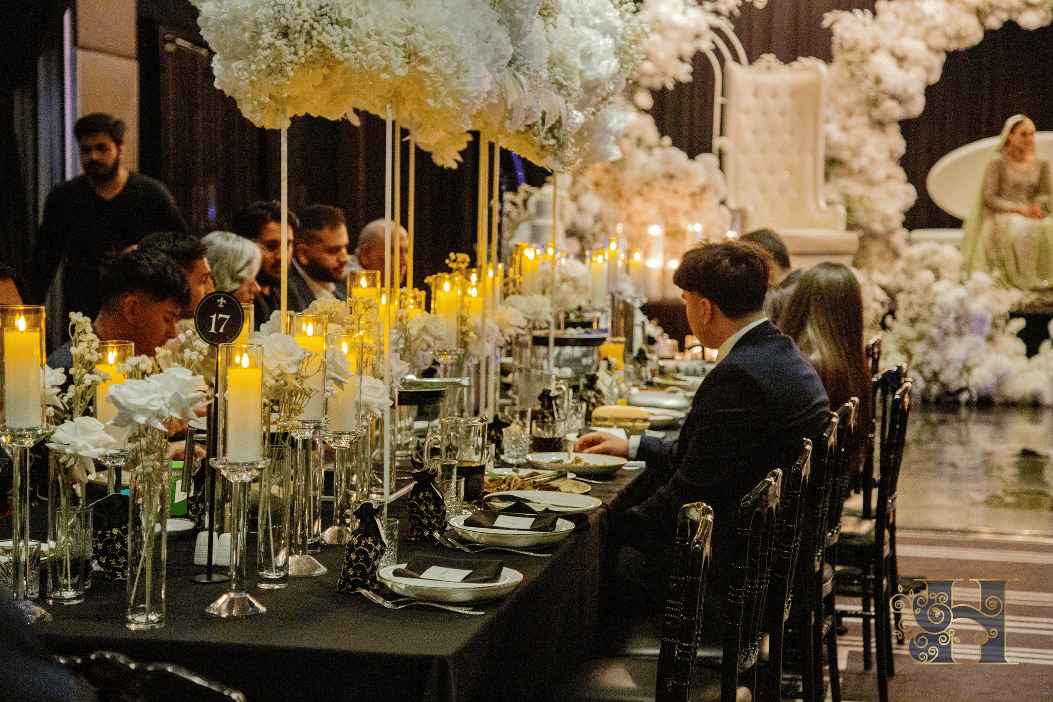 Group of people sitting at a table enjoying a plated-style dinner.